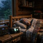 A person sleeps soundly with a CPAP machine powered by a portable station in a dimly lit room, illustrating off-grid survival during a storm.