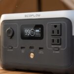 Close-up of the EcoFlow RIVER 2 portable power station showing the front LCD display, AC outlets, USB-C, and USB-A charging ports.